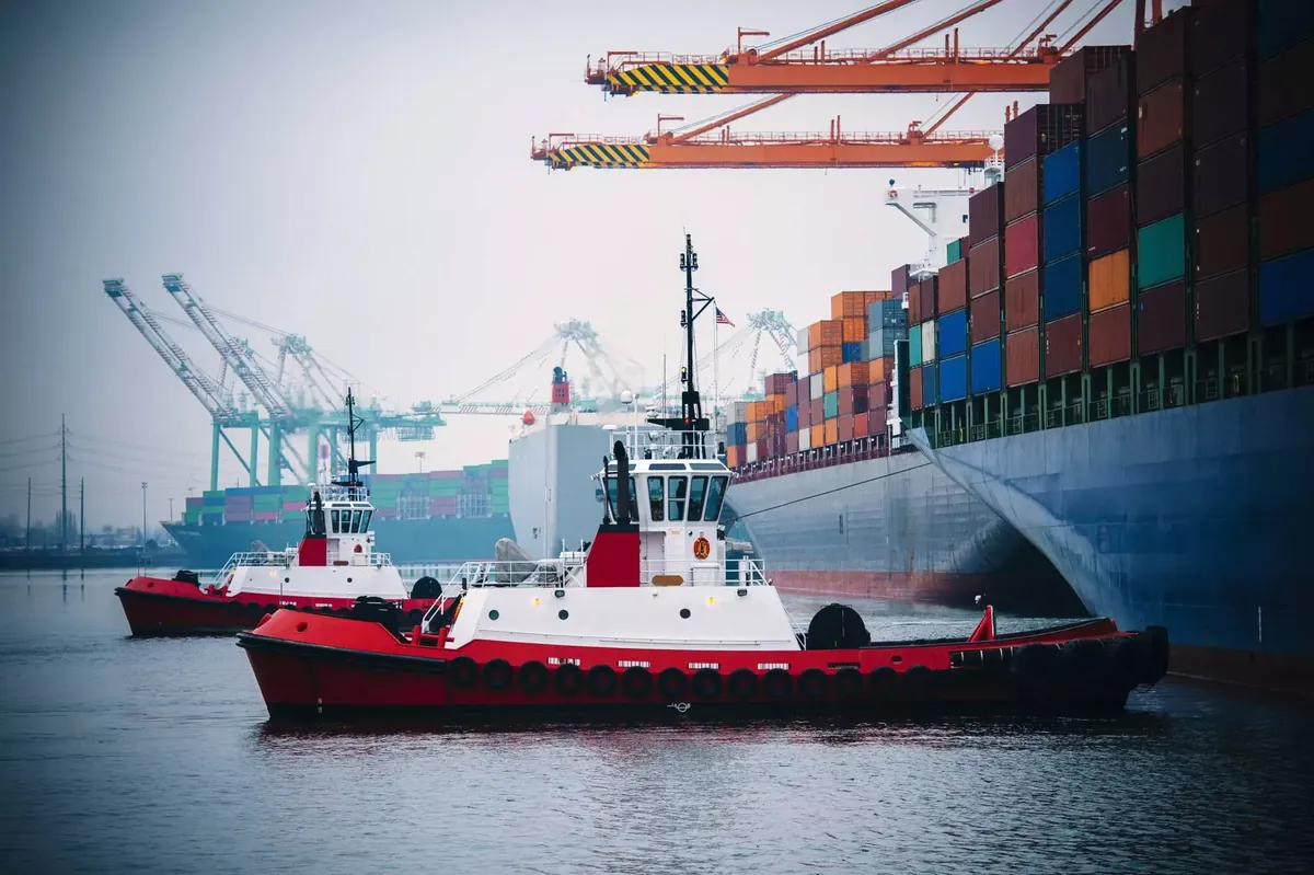 Tug and container vessel in Dubai Maritime City